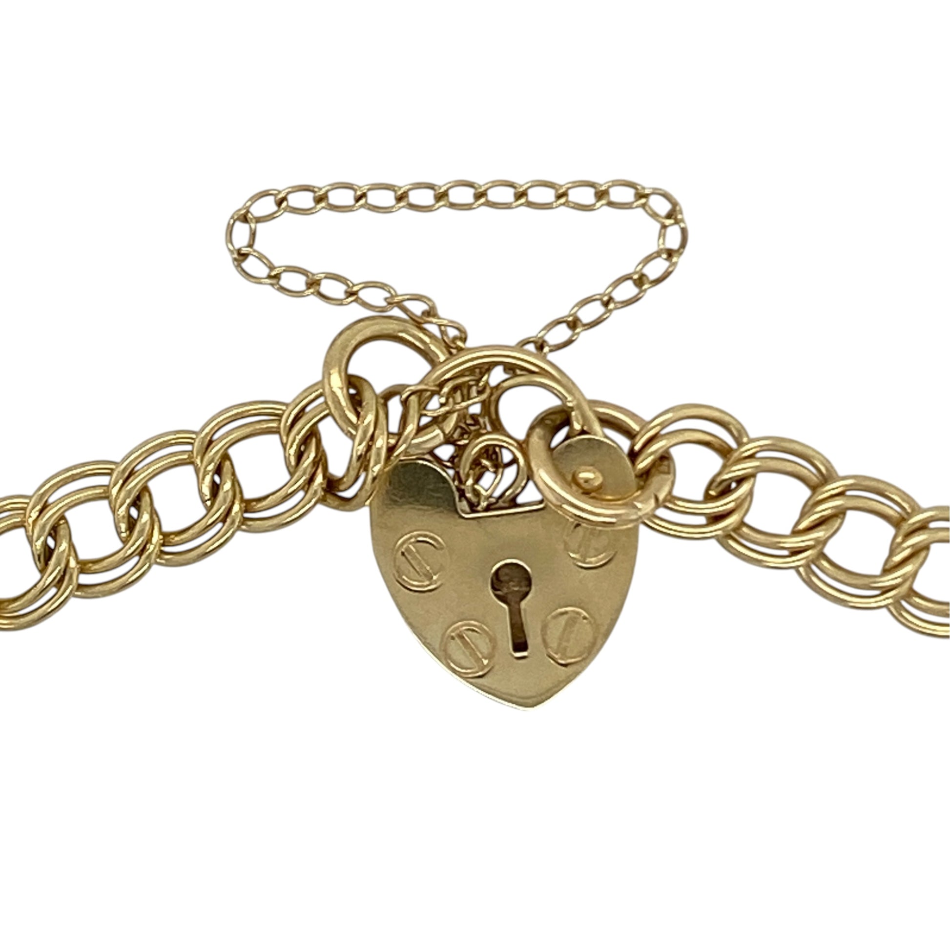 This pre-owned 9ct yellow gold heart padlock charm bracelet is a traditional design, featuring a selection of decorative charms and a safety chain.

Design: Featuring a classic charm bracelet design with a heart padlock fastening, this bracelet is finished in warm 9ct yellow gold and includes three decorative charms.
Material: Made from 9-carat yellow gold.
Bracelet Detail: Features a small heart locket charm, horseshoe charm and star charm, along with a safety chain.