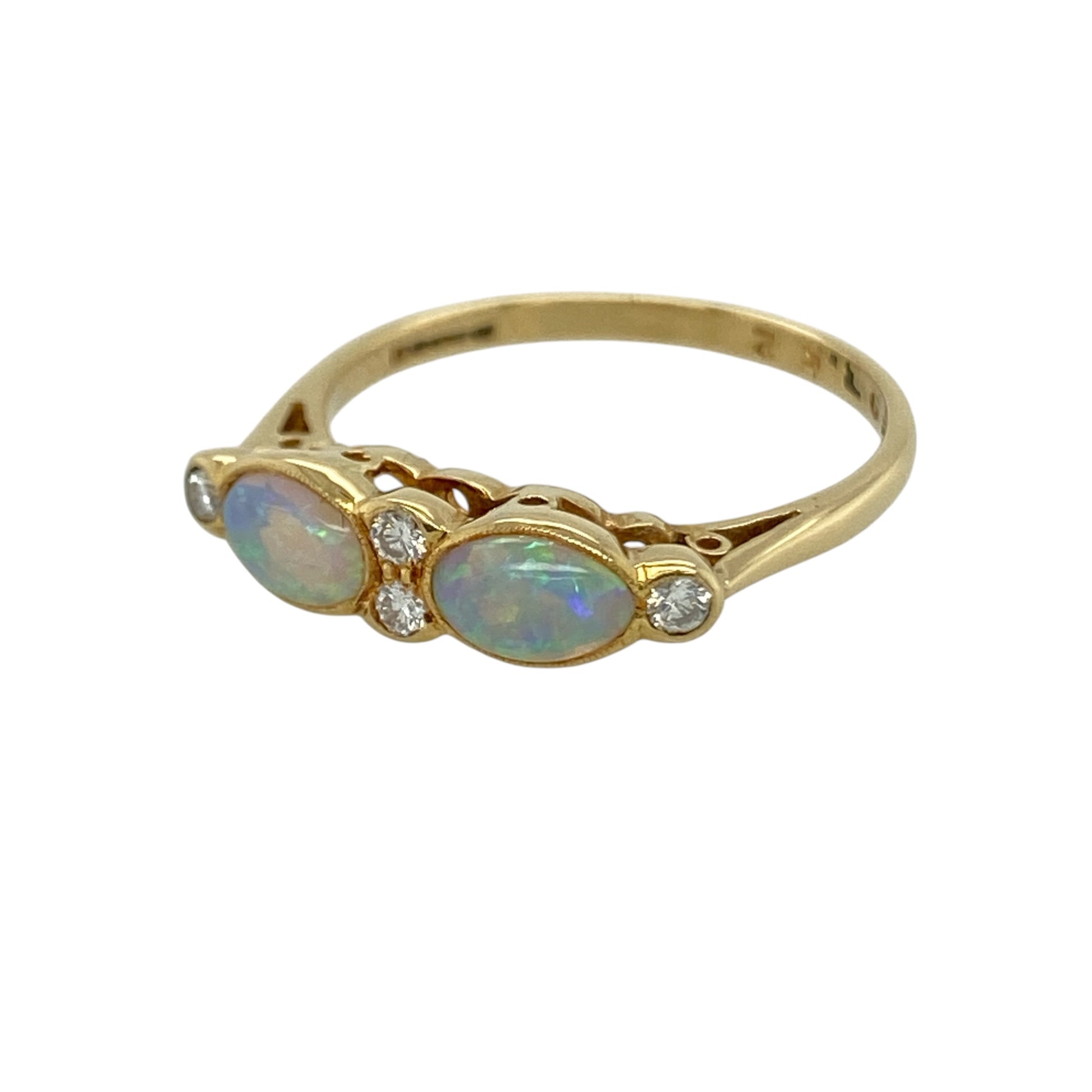 This pre-owned 18ct yellow gold diamond and opalique band ring is a colourful gemstone design, featuring opalique stones with diamond detailing.

Design: Featuring opalique stones with diamond detailing across the front, this band ring combines colourful tones with the warm finish of 18ct yellow gold.
Material: Made from 18-carat yellow gold.
Gemstone Detail: Opalique stones each measuring approximately 6mm by 4mm with diamond detailing.
Ring Detail: Diamond and opalique band ring design.