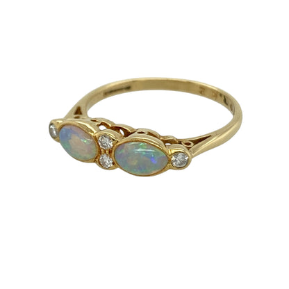 This pre-owned 18ct yellow gold diamond and opalique band ring is a colourful gemstone design, featuring opalique stones with diamond detailing.

Design: Featuring opalique stones with diamond detailing across the front, this band ring combines colourful tones with the warm finish of 18ct yellow gold.
Material: Made from 18-carat yellow gold.
Gemstone Detail: Opalique stones each measuring approximately 6mm by 4mm with diamond detailing.
Ring Detail: Diamond and opalique band ring design.