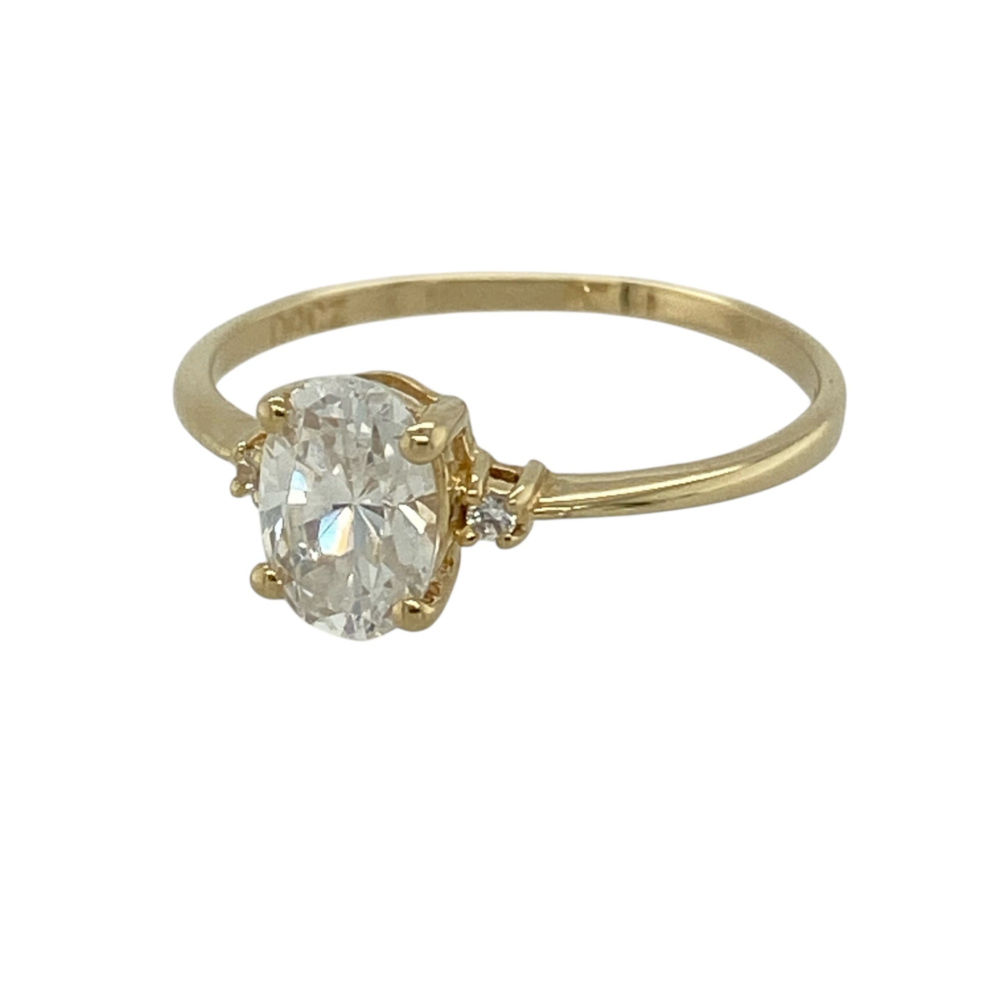 This pre-owned 14ct yellow gold cubic zirconia solitaire ring is a classic stone-set design, featuring an oval centre stone with smaller cubic zirconia detailing on either side.

Design: Featuring an oval cubic zirconia centre stone with a smaller round stone set on either side, this ring has a classic design finished in warm 14ct yellow gold.
Material: Made from 14-carat yellow gold.