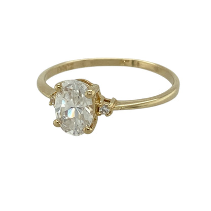 This pre-owned 14ct yellow gold cubic zirconia solitaire ring is a classic stone-set design, featuring an oval centre stone with smaller cubic zirconia detailing on either side.

Design: Featuring an oval cubic zirconia centre stone with a smaller round stone set on either side, this ring has a classic design finished in warm 14ct yellow gold.
Material: Made from 14-carat yellow gold.