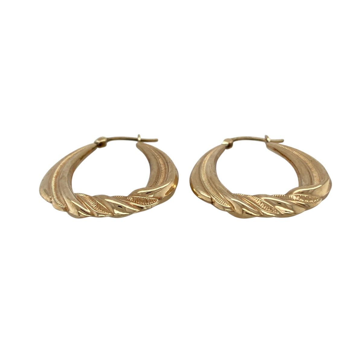 These pre-owned 9ct yellow gold patterned twist oval creole earrings are a decorative design, featuring twisted detailing along the lower section.

Design: Featuring an oval creole shape with patterned twist detailing along the bottom, these earrings have a decorative finish in warm 9ct yellow gold.
Material: Made from 9-carat yellow gold.
Earring Detail: Oval creole earring design with patterned twist detailing along the bottom.
Size & Weight: Total weight 2.60 grams.