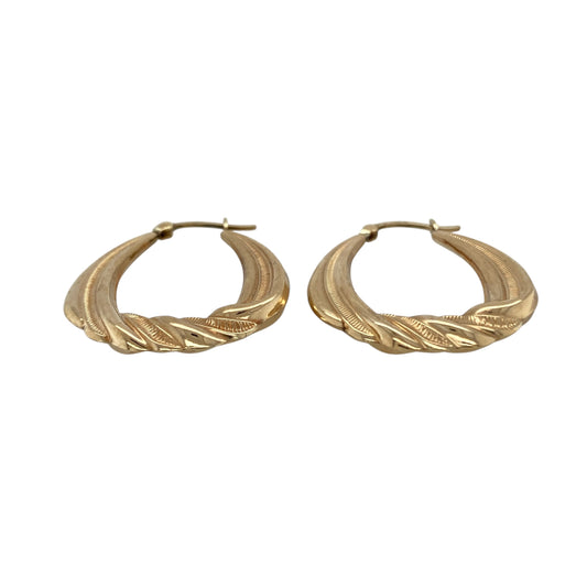 These pre-owned 9ct yellow gold patterned twist oval creole earrings are a decorative design, featuring twisted detailing along the lower section.

Design: Featuring an oval creole shape with patterned twist detailing along the bottom, these earrings have a decorative finish in warm 9ct yellow gold.
Material: Made from 9-carat yellow gold.
Earring Detail: Oval creole earring design with patterned twist detailing along the bottom.
Size & Weight: Total weight 2.60 grams.