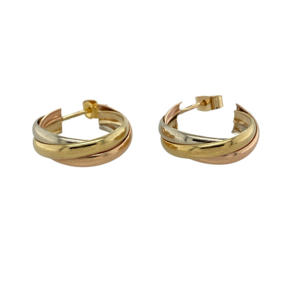 These pre-owned 9ct yellow, white and rose gold three band twist half hoop earrings are a distinctive three-tone design, featuring intertwined bands of contrasting gold.

Design: Featuring three twisted bands in yellow, white and rose gold, these half hoop earrings have a decorative intertwined three-tone finish.
Material: Made from 9-carat yellow, white and rose gold.
Earring Detail: Three band twist half hoop earring design.
Size & Weight: Total weight 3 grams.