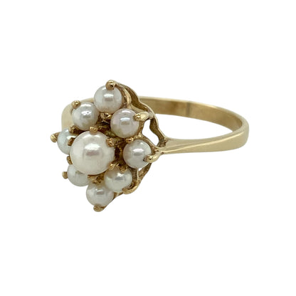 This pre-owned 9ct yellow gold pearl marquise-shaped cluster ring is a classic decorative design, featuring pearls arranged in an elongated cluster setting.

Design: Featuring a marquise-shaped cluster design set with pearls, this ring has an elegant elongated profile finished in warm 9ct yellow gold.
Material: Made from 9-carat yellow gold.
Gemstone Detail: Set with pearls in a marquise-shaped cluster arrangement.
Ring Detail: Front of the ring measures approximately 14mm high.