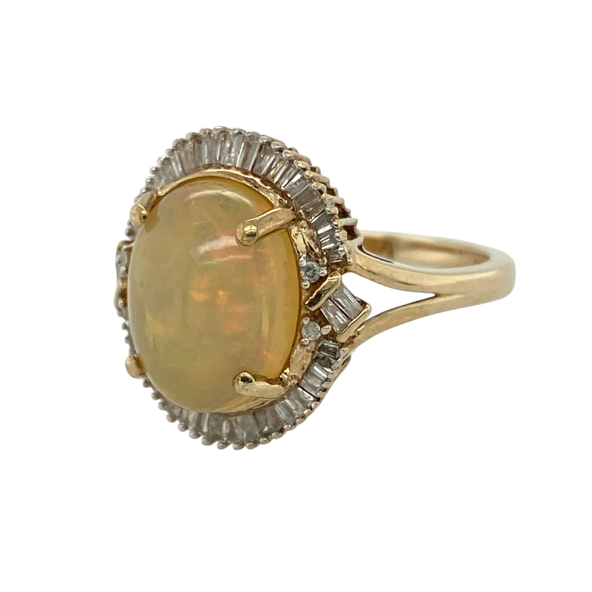 This pre-owned 9ct yellow gold diamond and opalique cluster ring is a striking gemstone design, featuring a large oval opalique surrounded by baguette cut diamonds.

Design: Featuring an oval opalique centre stone surrounded by baguette cut diamonds in a cluster setting, this ring is finished in warm 9ct yellow gold.
Material: Made from 9-carat yellow gold.
Gemstone Detail: Oval opalique stone measuring approximately 12mm by 10mm, surrounded by baguette cut diamonds.