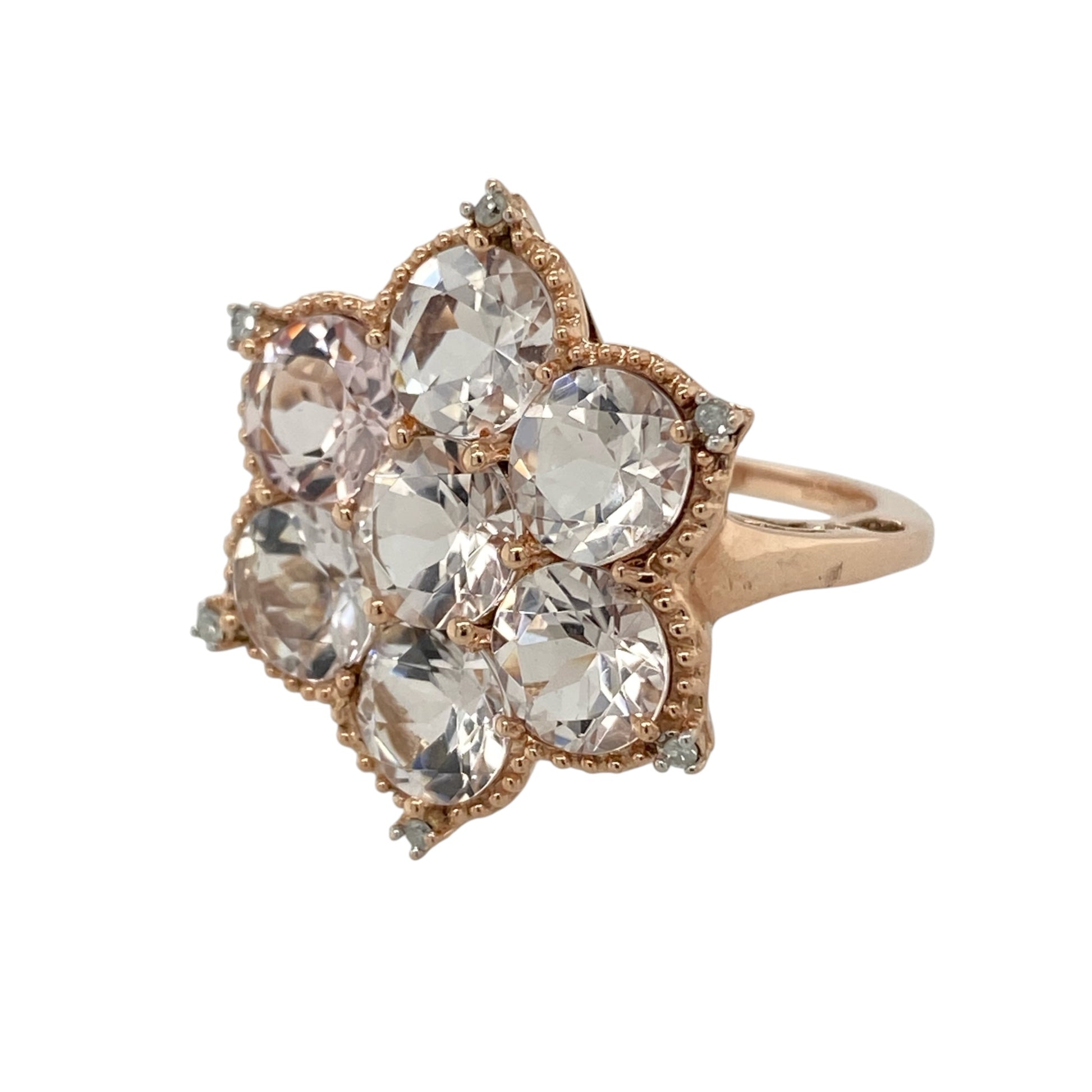 This pre-owned 9ct rose gold diamond and pink quartz flower ring is a bold floral design, featuring seven pink quartz stones with diamond detailing.

Design: Featuring a large flower-shaped design formed from seven round pink quartz stones, this ring is finished in warm 9ct rose gold with diamond detailing at each point.
Material: Made from 9-carat rose gold.
Gemstone Detail: Seven round pink quartz stones, each measuring approximately 6mm in diameter, with diamonds set at each point.