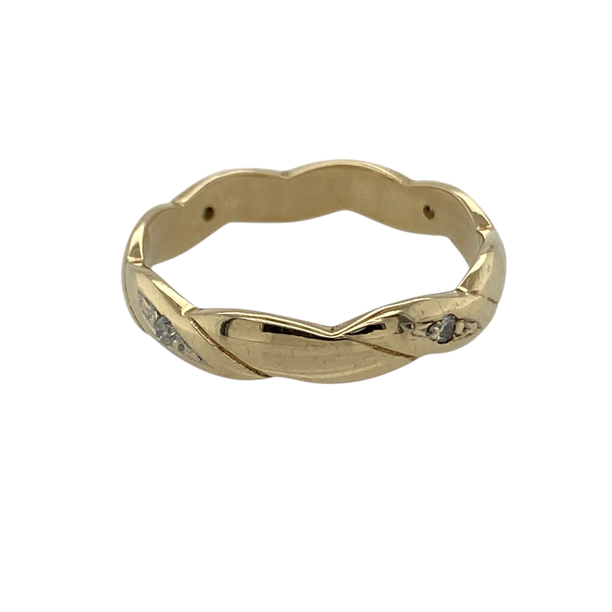 This pre-owned 9ct yellow gold diamond twisted band ring is a decorative design, featuring diamond detailing within a flowing twisted band.

Design: Featuring a twisted band design with diamond detailing, this ring has a flowing profile finished in warm 9ct yellow gold.
Material: Made from 9-carat yellow gold.
Gemstone Detail: Set with diamonds.
Ring Detail: Twisted band measures approximately 3mm wide.
Size & Weight: Ring size M. Total weight 2.10 grams.