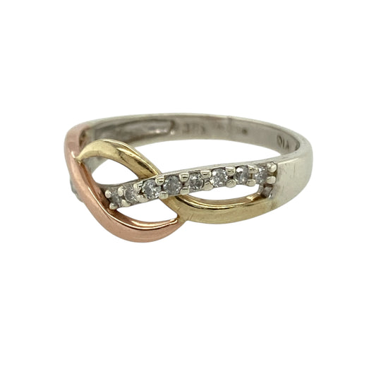 This pre-owned 9ct white, rose and yellow gold diamond open weave band ring is a distinctive three-tone design, featuring diamond detailing within an open patterned setting.

Design: Featuring an open weave band design with diamond detailing, this ring combines white, rose and yellow gold for a contrasting three-tone finish.
Material: Made from 9-carat white, rose and yellow gold.
Gemstone Detail: Set with diamonds.
Ring Detail: Open weave design measuring approximately 8mm wide across the front.