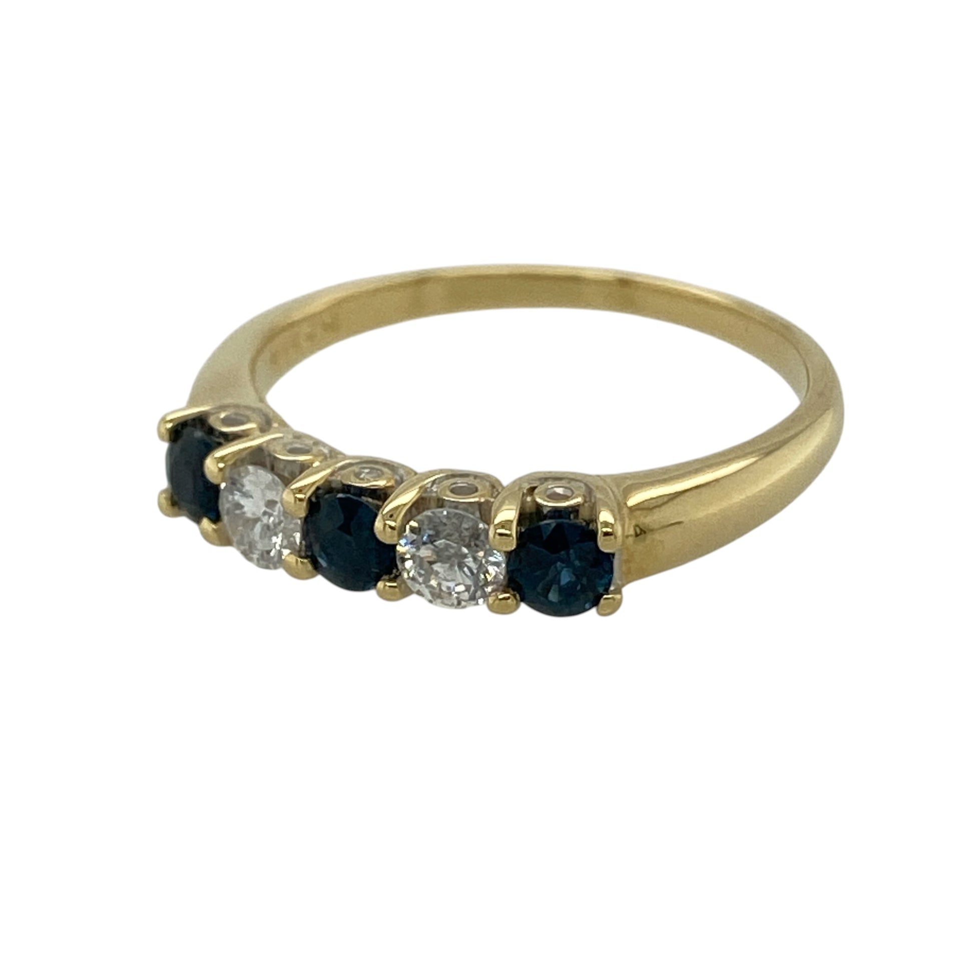 This pre-owned 18ct yellow gold diamond and sapphire band ring is a classic gemstone design, featuring alternating sapphires and brilliant cut diamonds.

Design: Featuring three round sapphires alternating with two brilliant cut diamonds across the front, this band ring combines rich blue tones with the warm finish of 18ct yellow gold.
Material: Made from 18-carat yellow gold.