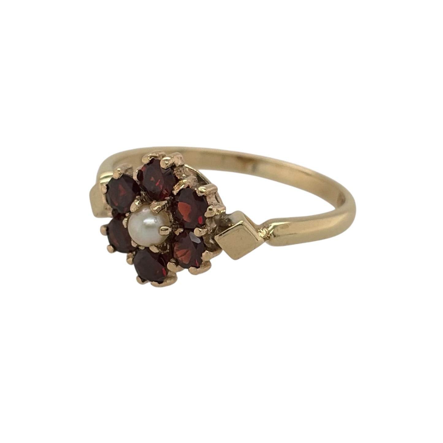 This pre-owned 9ct yellow gold garnet and pearl flower cluster ring is a classic floral design, combining rich red garnets with soft pearl tones.

Design: Featuring a flower-shaped cluster design set with garnets and pearls, this ring has a decorative floral appearance finished in warm 9ct yellow gold.
Material: Made from 9-carat yellow gold.
Gemstone Detail: Garnet and pearl stones each measuring approximately 3mm in diameter.
Ring Detail: Garnet and pearl flower cluster ring design.