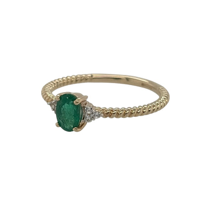 This pre-owned 9ct yellow gold emerald and cubic zirconia ring is a colourful gemstone design, featuring an oval emerald with cubic zirconia detailing within a twisted band.

Design: Featuring an oval emerald centre stone with cubic zirconia stones set on either side, this ring has a decorative twisted band finished in warm 9ct yellow gold.
Material: Made from 9-carat yellow gold.
Gemstone Detail: Oval emerald measuring approximately 6mm by 4mm with cubic zirconia stones set on either side.