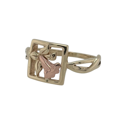 Bring Welsh heritage and graceful detail to your jewellery collection with this pre-owned 9ct yellow and rose gold Clogau daffodil ring — a beautifully symbolic piece inspired by the national flower of Wales.

Design: The front of the ring measures 10mm high and features a delicate daffodil motif, showcasing soft petal detailing and the signature Clogau styling.
Material: Made from 9ct yellow and rose gold, the warm tones highlight the floral design and add a distinctive two-tone touch.