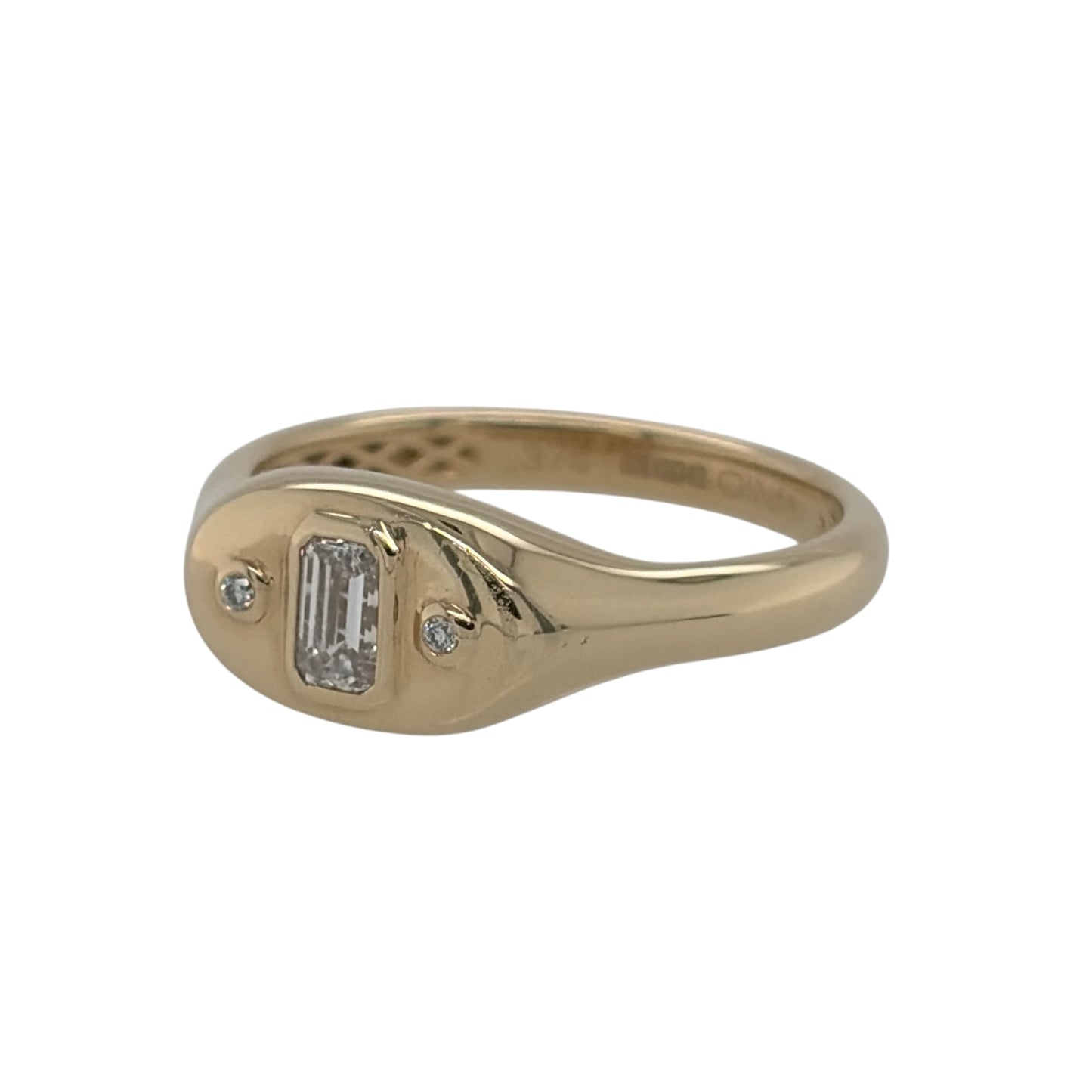 This pre-owned 9ct yellow gold diamond signet ring is a distinctive design, featuring an emerald cut centre diamond with a brilliant cut diamond set on either side.

Design: Featuring a classic signet-style profile, this ring combines a central emerald cut diamond with two smaller brilliant cut diamonds for a three stone design.
Material: Made from 9-carat yellow gold.
Gemstone Detail: Set with one emerald cut diamond in the centre and two smaller brilliant cut diamonds, one on either side.