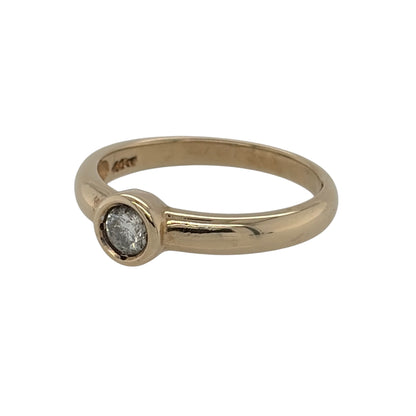 This pre-owned 9ct yellow gold diamond solitaire ring is a timeless design, featuring a brilliant cut diamond in a secure rubover-style setting.

Design: Featuring a classic solitaire design, this ring has a brilliant cut diamond set within a smooth rubover-style setting in warm 9ct yellow gold.
Material: Made from 9-carat yellow gold.
Gemstone Detail: Set with a brilliant cut diamond of approximately 0.20ct.
Ring Detail: Classic solitaire design with a rubover-style diamond setting.