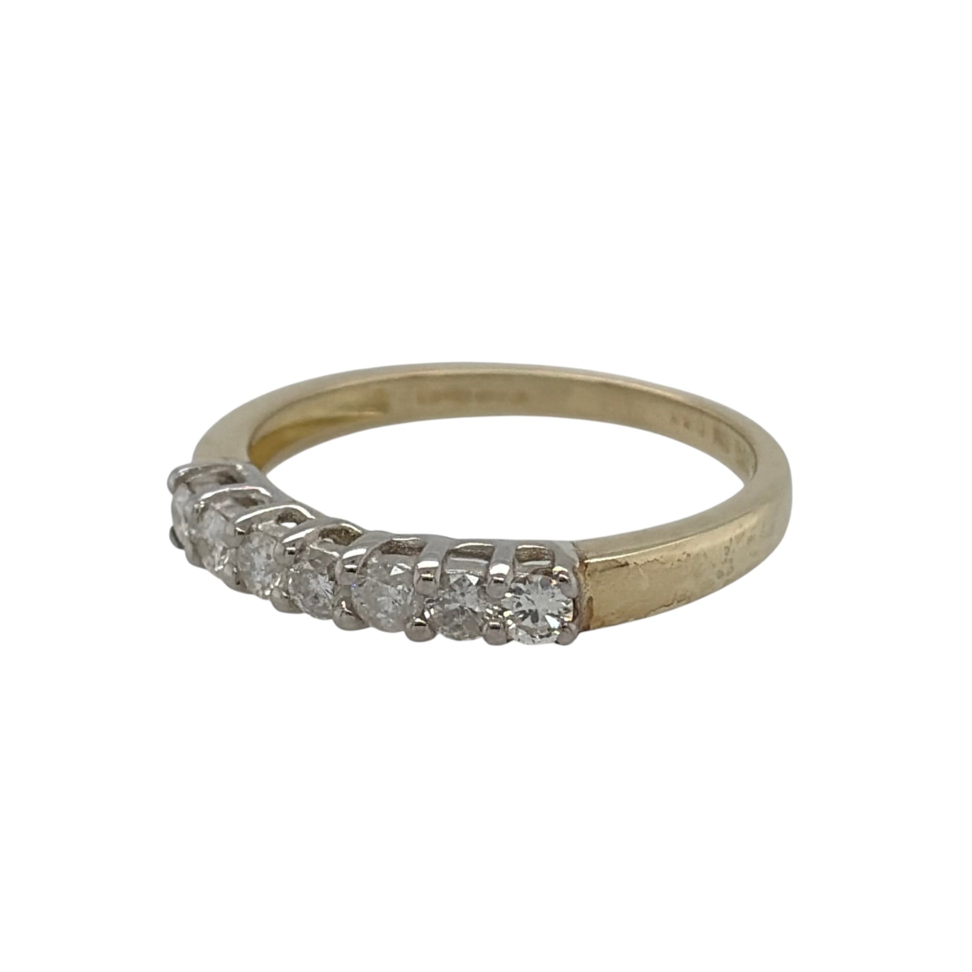 This pre-owned 9ct yellow gold diamond seven stone band ring is a classic design, featuring seven brilliant cut diamonds set across the front.

Design: Featuring a traditional seven stone design, this ring has a row of brilliant cut diamonds set across the front in warm 9ct yellow gold.
Material: Made from 9-carat yellow gold.
Gemstone Detail: Set with seven brilliant cut diamonds with approximately 0.33ct of diamond content in total.
Ring Detail: Seven stone diamond band design.