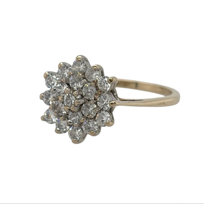 This pre-owned 9ct yellow gold cubic zirconia round cluster ring is a classic dress ring, featuring multiple cubic zirconia stones arranged in a round cluster design.

Design: Featuring a traditional round cluster design, this ring has multiple cubic zirconia stones arranged together in warm 9ct yellow gold.
Material: Made from 9-carat yellow gold.
Gemstone Detail: Set with multiple cubic zirconia stones forming a round cluster.
Ring Detail: The front of the ring measures approximately 11mm high.