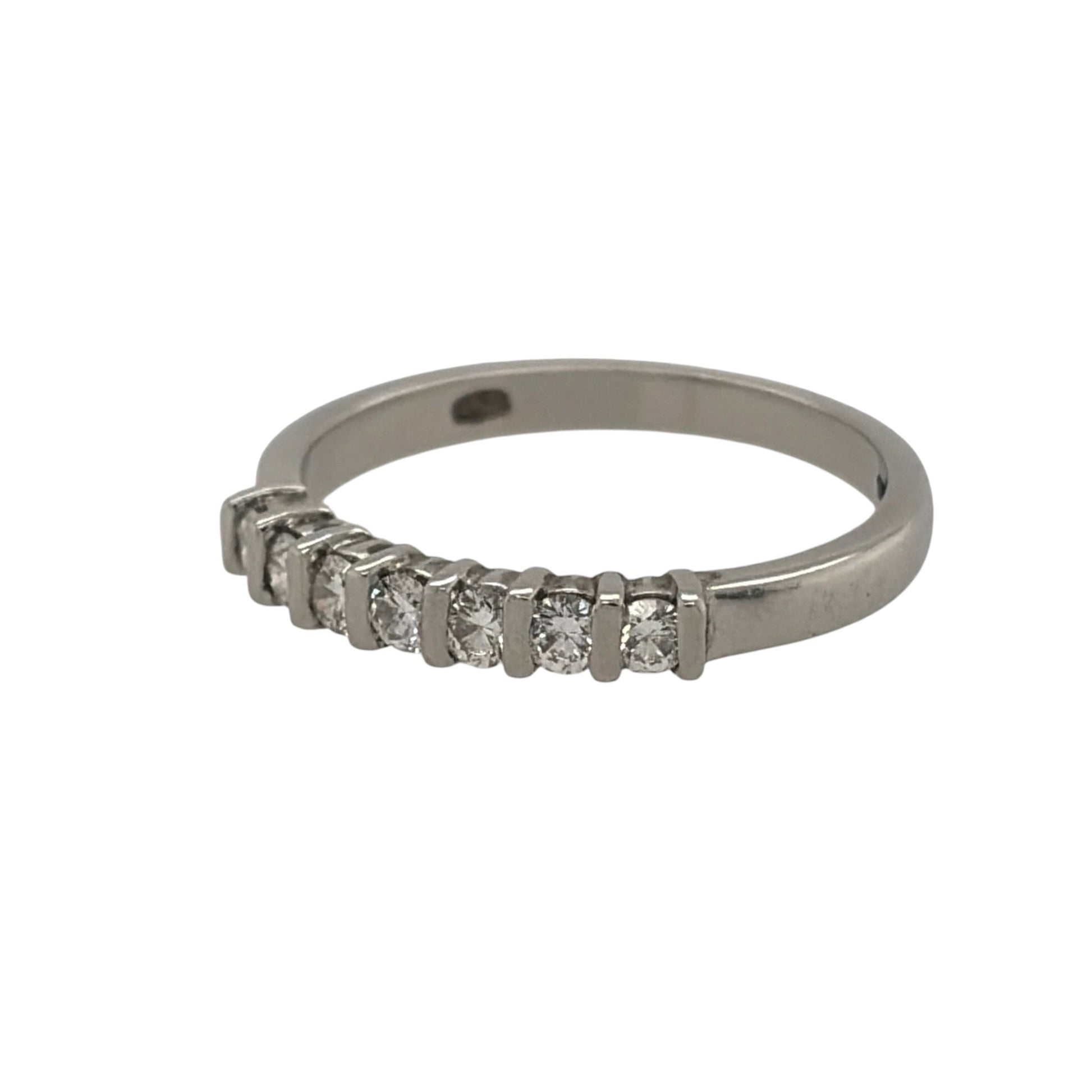 This pre-owned platinum diamond seven stone band ring is a timeless design, featuring seven diamonds set across the front of the band.

Design: Featuring a classic seven stone design, this ring has seven diamonds set across the front in platinum.
Material: Made from platinum.
Gemstone Detail: Set with seven diamonds across the front of the ring.
Ring Detail: The front of the band measures approximately 2mm wide.
Size & Weight: Ring size J. Total weight 2.80 grams.