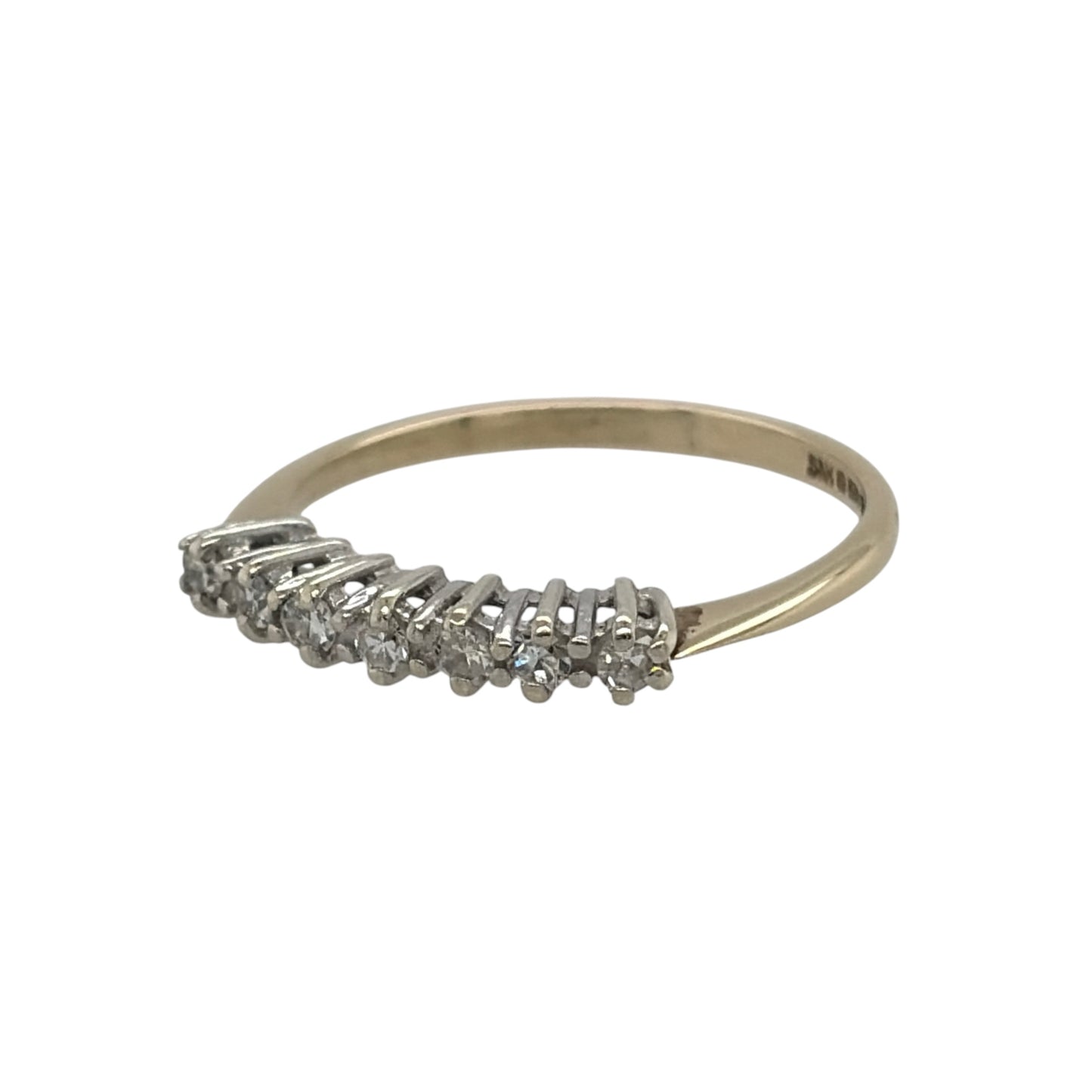 This pre-owned 9ct yellow gold diamond band ring is a classic design, featuring seven brilliant cut diamonds set across the front of the band.

Design: Featuring a traditional seven stone design, this ring has brilliant cut diamonds set across the front in warm 9ct yellow gold.
Material: Made from 9-carat yellow gold.
Gemstone Detail: Set with seven brilliant cut diamonds across the front of the ring.
Ring Detail: The front of the band measures approximately 2mm wide.