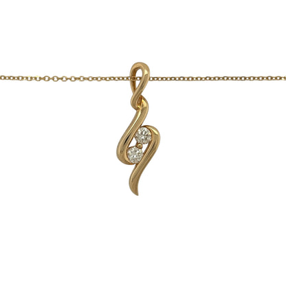 This pre-owned 18ct yellow gold double diamond wrap-around wave-style pendant necklace is a distinctive design, featuring two diamonds within a flowing curved pendant.

Design: Featuring a wrap-around wave-style design, this pendant has a flowing curved profile finished in warm 18ct yellow gold and suspended from a trace chain.
Material: Made from 18-carat yellow gold.
Gemstone Detail: Set with two diamonds within the wave-style design.
Pendant Detail: Pendant measures approximately 24mm by 8mm.