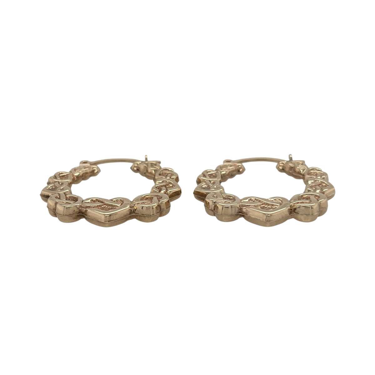 This pre-owned 9ct yellow gold Celtic heart hoop Creole earrings are a distinctive design, featuring decorative heart and Celtic-inspired detailing.

Design: Featuring a hoop Creole shape with Celtic heart detailing, these earrings have a decorative finish in warm 9ct yellow gold.
Material: Made from 9-carat yellow gold.
Earring Detail: Hoop Creole design featuring Celtic-inspired heart detailing.
Size & Weight: Total combined weight 1.90 grams.