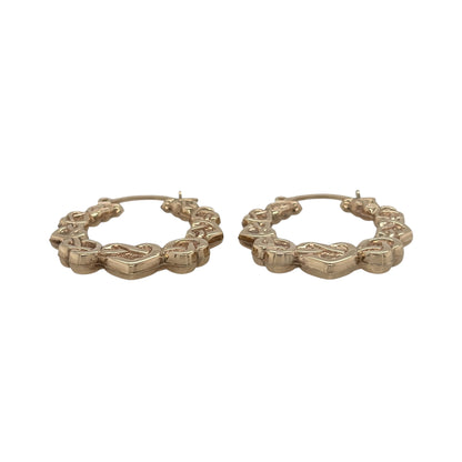 This pre-owned 9ct yellow gold Celtic heart hoop Creole earrings are a distinctive design, featuring decorative heart and Celtic-inspired detailing.

Design: Featuring a hoop Creole shape with Celtic heart detailing, these earrings have a decorative finish in warm 9ct yellow gold.
Material: Made from 9-carat yellow gold.
Earring Detail: Hoop Creole design featuring Celtic-inspired heart detailing.
Size & Weight: Total combined weight 1.90 grams.
