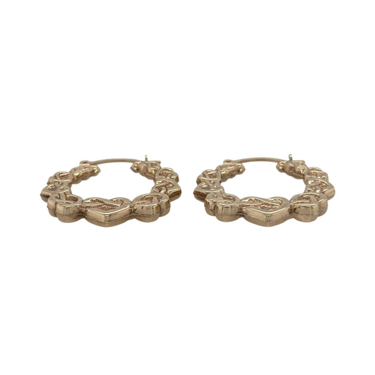 This pre-owned 9ct yellow gold Celtic heart hoop Creole earrings are a distinctive design, featuring decorative heart and Celtic-inspired detailing.

Design: Featuring a hoop Creole shape with Celtic heart detailing, these earrings have a decorative finish in warm 9ct yellow gold.
Material: Made from 9-carat yellow gold.
Earring Detail: Hoop Creole design featuring Celtic-inspired heart detailing.
Size & Weight: Total combined weight 1.90 grams.