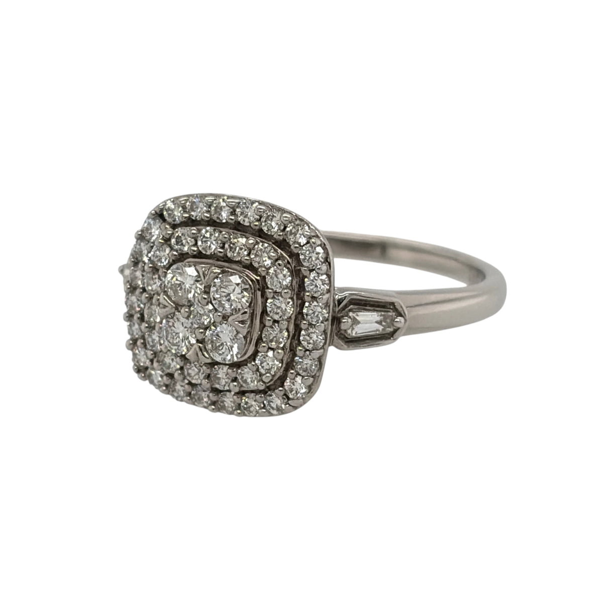 This pre-owned 9ct white gold diamond double halo cluster ring is a striking design, featuring a cushion-shaped profile with multiple rows of diamond detailing.

Design: Featuring a cushion-shaped cluster with a double halo design, this ring has multiple diamonds arranged across the front for a bold and detailed appearance.
Material: Made from 9-carat white gold.
Gemstone Detail: Set with approximately 0.61ct of diamond content in total throughout the cluster design.