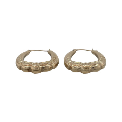 This pre-owned 9ct yellow gold Celtic knot oval Creole earrings are a distinctive design, featuring traditional Celtic-inspired detailing.

Design: Featuring an oval Creole shape with decorative Celtic knot detailing, these earrings have a traditional patterned finish in warm 9ct yellow gold.
Material: Made from 9-carat yellow gold.
Earring Detail: Oval Creole design featuring traditional Celtic knot patterned detailing.
Size & Weight: Total combined weight 1.30 grams.