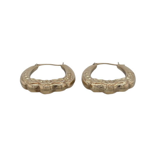 This pre-owned 9ct yellow gold Celtic knot oval Creole earrings are a distinctive design, featuring traditional Celtic-inspired detailing.

Design: Featuring an oval Creole shape with decorative Celtic knot detailing, these earrings have a traditional patterned finish in warm 9ct yellow gold.
Material: Made from 9-carat yellow gold.
Earring Detail: Oval Creole design featuring traditional Celtic knot patterned detailing.
Size & Weight: Total combined weight 1.30 grams.
