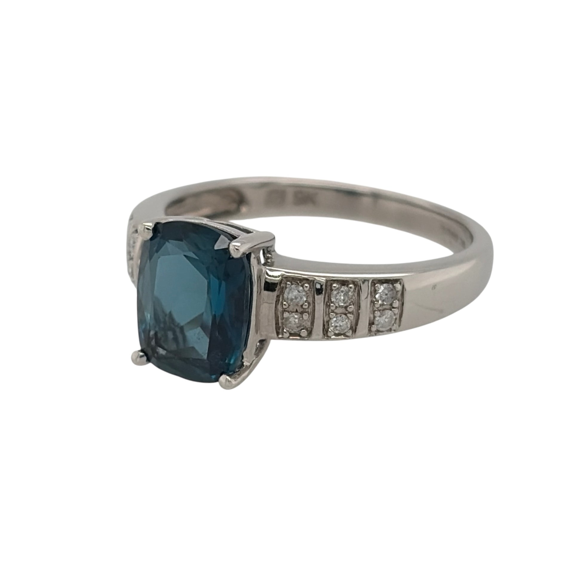 This pre-owned 9ct white gold diamond and blue topaz ring is a classic gemstone design, featuring a rectangular blue topaz centre stone complemented by diamond detailing.

Design: Featuring a rectangular blue topaz as the centrepiece, this ring combines bright blue tones with diamond detailing in 9ct white gold.
Material: Made from 9-carat white gold.
Gemstone Detail: Set with a rectangular blue topaz measuring approximately 9mm by 7mm, complemented by diamond detailing.