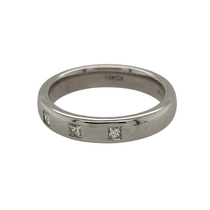 This pre-owned 9ct white gold diamond band ring is a classic design, featuring four princess cut diamonds set across the band.

Design: Featuring a simple band design, this ring has four princess cut diamonds set across the front for a clean geometric appearance.
Material: Made from 9-carat white gold.
Gemstone Detail: Set with four princess cut diamonds across the band.
Ring Detail: Band measures approximately 4mm wide.
Size & Weight: Ring size L to M. Total weight 4.80 grams.