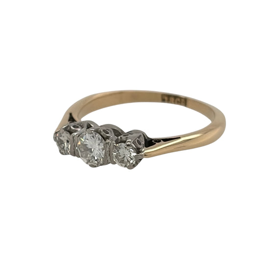 This pre-owned 18ct yellow gold diamond trilogy ring is a timeless design, featuring three diamonds set together across the front of the ring.

Design: Featuring a classic trilogy design, this ring has three diamonds arranged across the front and finished in warm 18ct yellow gold.
Material: Made from 18-carat yellow gold.
Gemstone Detail: Set with three diamonds with approximately 0.25ct of diamond content in total.
Ring Detail: Classic three stone trilogy setting designed to showcase the diamonds.