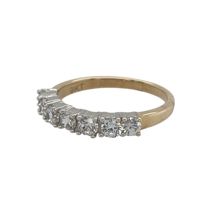 New 9ct Yellow Gold &amp; Cubic Zirconia Seven Stone Band Ring in various sizes with the approximate weight 2.40 grams. The front of the ring is 3mm wide