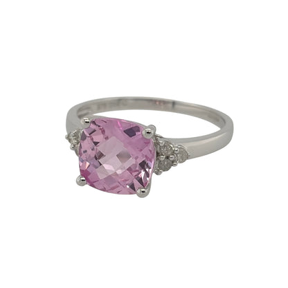 New 9ct White Gold Diamond &amp; created Pink Sapphire Ring in various sizes with the approx weight 2.20 grams. There is approximatley 0.08ct of diamond content in the ring has approximate clarity i2-i3 and colour H - I. The created cushion cut pink sapphire stone is 8mm by 8mm