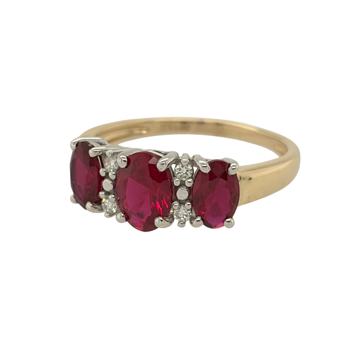 New 9ct Gold Lab Grown Diamond &amp; Lab Grown Ruby Trilogy Cluster Ring in various sizes with the approx weight 2.25 grams. There is approximatley 0.20ct of lab grown diamond content in the ring has approximate clarity i2 and colour J. The center lab grown ruby oval stone is 7mm by 5mm and the side ones are 6mm by 4mm