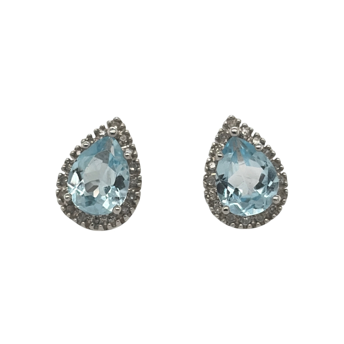 New 9ct White Gold Diamond &amp; Blue Topaz Cluster Stud Earrings with the weight 2.50 grams. The teardrop topaz stone is 8mm by 6mm and the earrings contain approximatley 0.13ct of diamond content in total with approximate clarity i2-13 and colour H - I