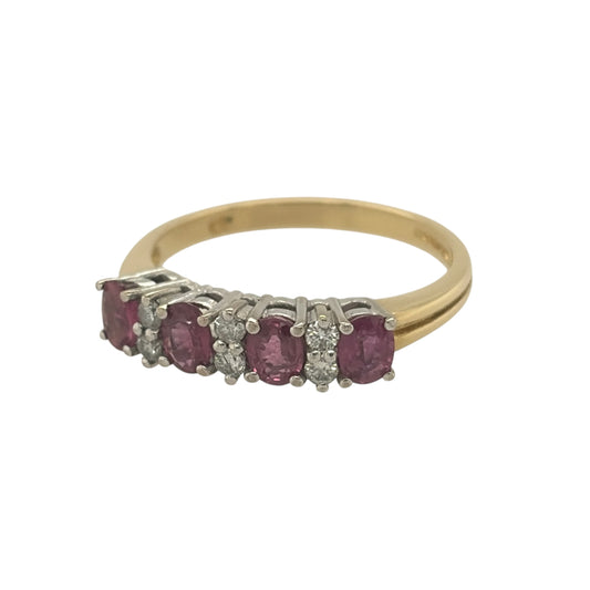 This pre-owned 18ct yellow gold diamond and ruby band ring is a classic gemstone design, featuring oval rubies with diamond detailing set between.

Design: Featuring a traditional gemstone band design, this ring has oval rubies arranged across the front with diamonds set between in warm 18ct yellow gold.
Material: Made from 18-carat yellow gold.
Gemstone Detail: Set with oval ruby stones measuring approximately 4mm by 3.5mm each, complemented by diamonds set between.