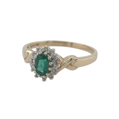 This pre-owned 9ct yellow gold diamond and green stone cluster ring is a classic gemstone design, featuring an oval emerald-coloured centre stone complemented by diamond detailing.

Design: Featuring a traditional cluster design, this ring showcases an oval green centre stone surrounded by diamond detailing and finished in warm 9ct yellow gold.
Material: Made from 9-carat yellow gold.