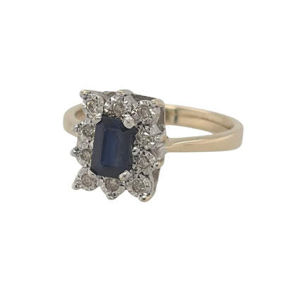 This pre-owned 9ct yellow gold diamond and sapphire cluster ring is a classic gemstone design, featuring a rectangular sapphire centre stone complemented by diamond detailing.

Design: Featuring a traditional cluster design, this ring showcases a rectangular sapphire as the centrepiece, surrounded by diamonds and finished in warm 9ct yellow gold.
Material: Made from 9-carat yellow gold.