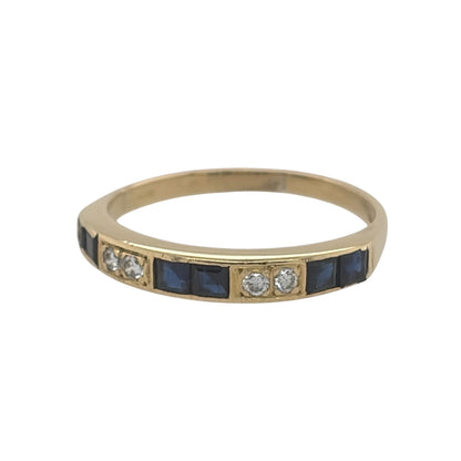 This pre-owned 18ct yellow gold diamond and sapphire band ring is a classic gemstone design, featuring sapphire and diamond detailing across the front.

Design: Featuring a traditional gemstone band design, this ring combines sapphires and diamonds across the front in warm 18ct yellow gold.
Material: Made from 18-carat yellow gold.
Gemstone Detail: Set with sapphire and diamond detailing across the front of the ring.
Ring Detail: The front of the band measures approximately 3mm wide.