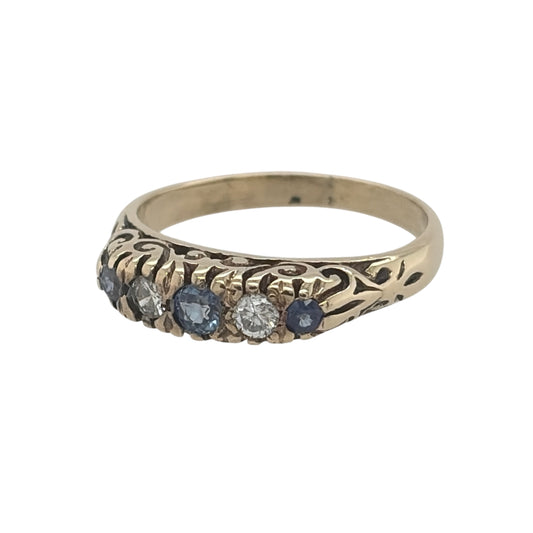 This pre-owned 9ct yellow gold diamond and sapphire band ring is a classic gemstone design, featuring sapphire and diamond detailing across the front.

Design: Featuring a traditional gemstone band design, this ring combines sapphires and diamonds across the front in warm 9ct yellow gold.
Material: Made from 9-carat yellow gold.
Gemstone Detail: Set with sapphire and diamond detailing across the front of the ring.
Ring Detail: The front of the band measures approximately 4mm wide.