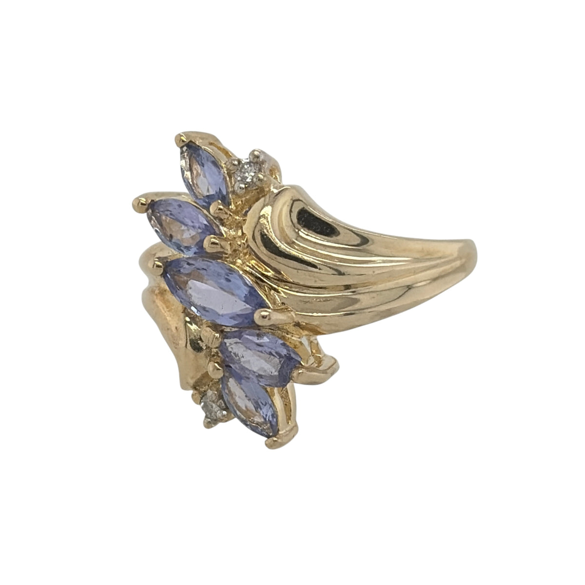 This pre-owned 9ct yellow gold diamond and tanzanite dress ring is a striking statement design, featuring five marquise cut tanzanite stones complemented by diamond detailing.

Design: Featuring a bold dress ring design, this ring has five marquise cut tanzanite stones arranged across the front with diamond detailing in warm 9ct yellow gold.
Material: Made from 9-carat yellow gold.
Gemstone Detail: Set with five marquise cut tanzanite stones, complemented by diamond detailing.