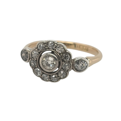This pre-owned 18ct yellow gold diamond Art Deco-style flower cluster ring is a distinctive vintage-inspired design, featuring multiple diamonds arranged in a decorative floral cluster.

Design: Featuring an Art Deco-style flower cluster design, this ring has multiple diamonds arranged across the front in a decorative floral pattern finished in warm 18ct yellow gold.
Material: Made from 18-carat yellow gold.
Gemstone Detail: Set with approximately 0.40ct to 0.45ct of diamond content in total.