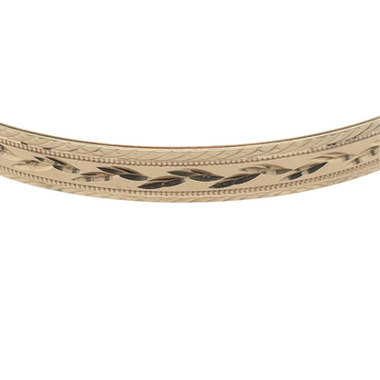 This pre-owned 9ct yellow solid gold patterned bangle is a substantial design, featuring decorative detailing across its warm yellow gold finish.

Design: Featuring decorative patterned detailing, this bangle has a classic profile with a traditional yellow gold finish.
Material: Made from solid 9-carat yellow gold.
Bangle Detail: The bangle measures approximately 6.5mm wide.
Size & Weight: Bangle measures approximately 6.7cm in diameter. Total weight 10.30 grams.