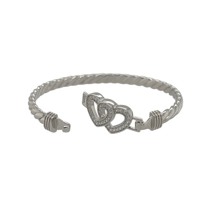 This new 925 sterling silver cubic zirconia set children’s double heart twisted bangle is a pretty design, featuring two heart details across the front.

Design: Featuring a twisted bangle design with a double heart centrepiece, this children’s bangle has a polished silver finish with cubic zirconia detailing.
Material: Made from 925 sterling silver.
Gemstone Detail: Set with cubic zirconia stones for added detail across the design.