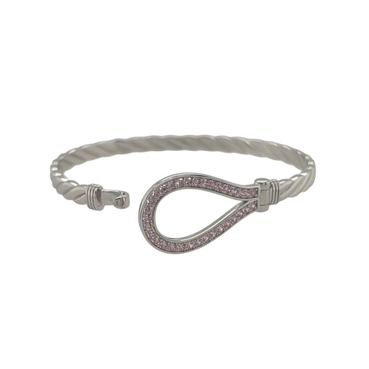 This new 925 sterling silver pink cubic zirconia set children’s horseshoe twisted bangle is a pretty design, featuring a horseshoe centrepiece with colourful stone detailing.

Design: Featuring a twisted bangle design with a horseshoe centrepiece, this children’s bangle has a polished silver finish with pink cubic zirconia detailing.
Material: Made from 925 sterling silver.
Gemstone Detail: Set with pink cubic zirconia stones across the horseshoe design.