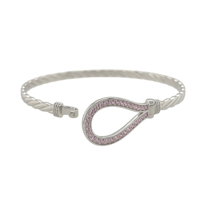 This new 925 sterling silver pink cubic zirconia set horseshoe bangle is a distinctive design, featuring a horseshoe centrepiece with colourful stone detailing.

Design: Featuring a horseshoe design across the front, this bangle has a polished silver finish with pink cubic zirconia detailing.
Material: Made from 925 sterling silver.
Gemstone Detail: Set with pink cubic zirconia stones across the horseshoe design.
Bangle Detail: The front of the bangle measures approximately 17mm high.
