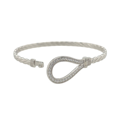 This new 925 sterling silver cubic zirconia set horseshoe bangle is a distinctive design, featuring a horseshoe centrepiece with stone detailing.

Design: Featuring a horseshoe design across the front, this bangle has a polished silver finish with cubic zirconia detailing.
Material: Made from 925 sterling silver.
Gemstone Detail: Set with cubic zirconia stones across the horseshoe design.
Bangle Detail: The front of the bangle measures approximately 17mm high.