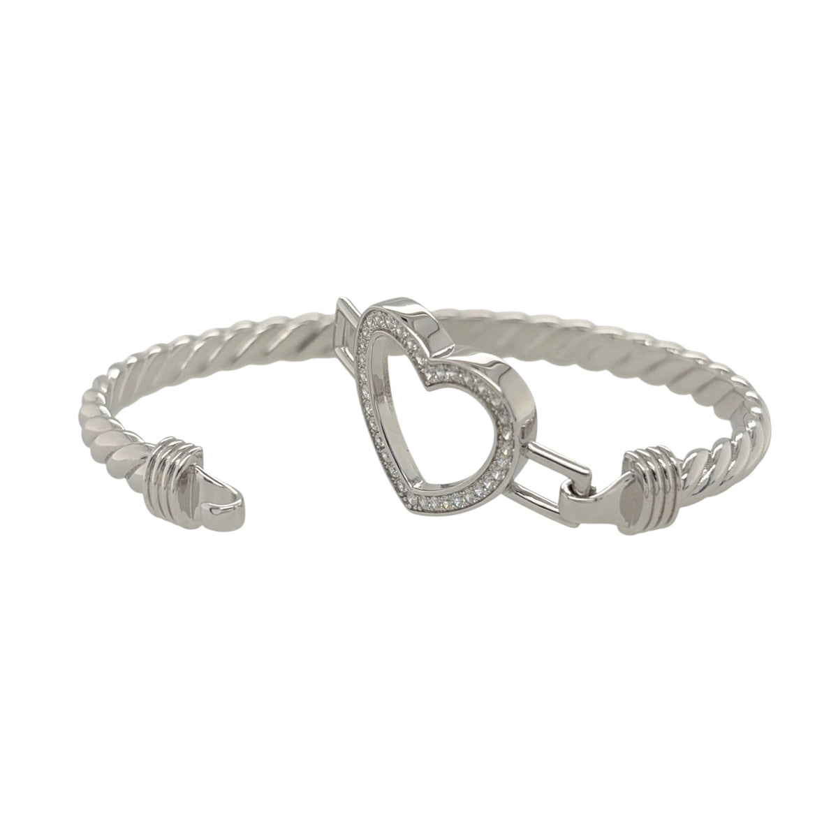 This new 925 sterling silver cubic zirconia set open heart twisted bangle is a stylish design, featuring an open heart centrepiece with stone detailing.

Design: Featuring a twisted bangle design with an open heart centrepiece, this bangle has a polished silver finish with cubic zirconia detailing.
Material: Made from 925 sterling silver.
Gemstone Detail: Set with cubic zirconia stones across the open heart design.
Bangle Detail: The front of the bangle measures approximately 21mm high.